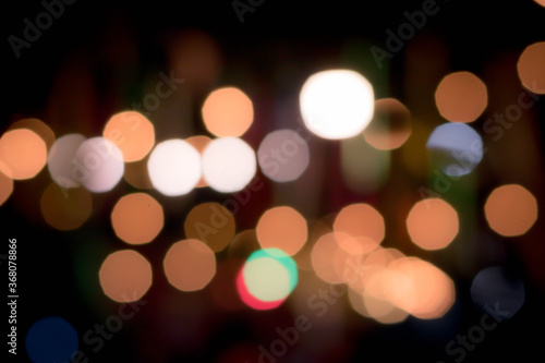 Blur the lights on the restaurant. Blurred cafe background with bokeh. orange ,red, light, blue, green, pink. © Nanthicha Khamphumee