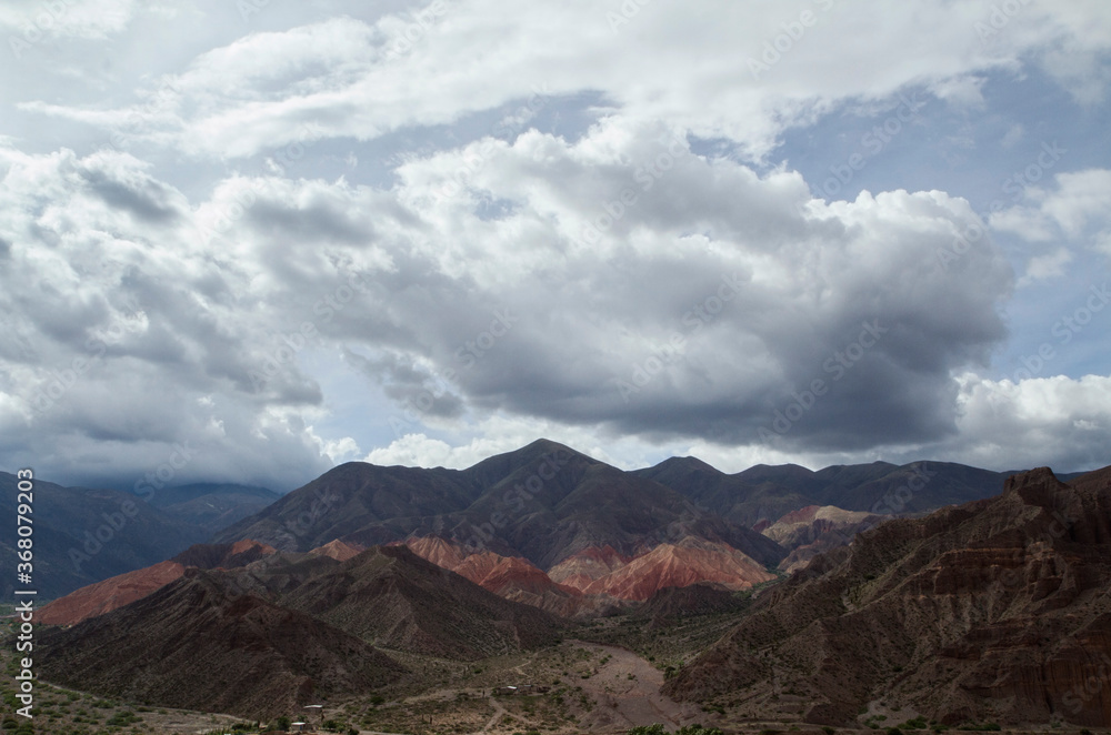 Andes mountain range. View of the colorful mountains and desert under a dramatic sky in Tilcara, Jujuy, Argentina. 