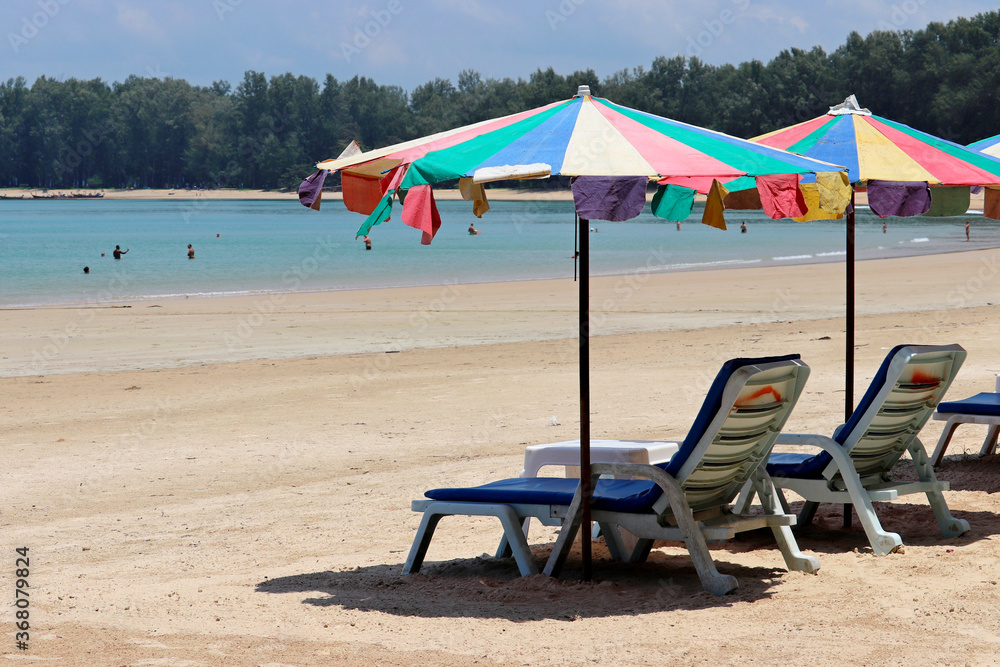 Sea sandy beach with empty sunbeds and umbrellas, selective focus. Vacation on summer resort during coronavirus pandemic Sea sandy beach with empty sunbeds and umbrellas, selective focus. Vacation on summer resort during coronavirus pandemic