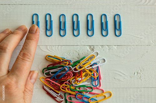 Schilderij op canvas colorful  paper clips on white background, office life, perfectionism, psycholog