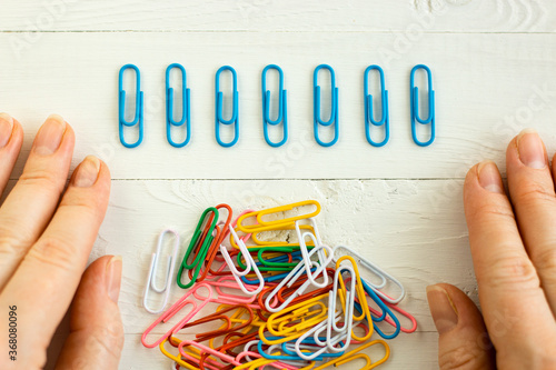colorful  paper clips on white background, office life, perfectionism, psychological training photo