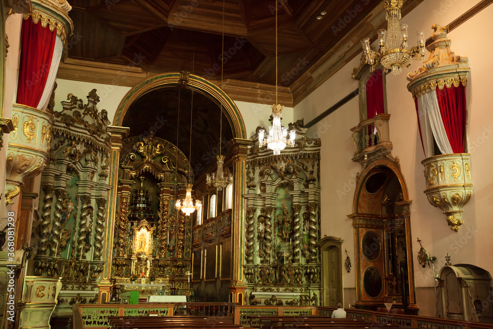 Obraz premium ancient church wide-angle view inside with local saints of faith and christian worship golden green and red details