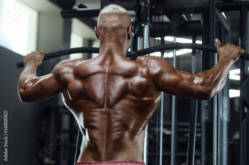 fitness man doing pull-ups exercises