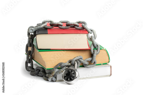 censorship concept, a lock and chain around a stack of old books isolated on white