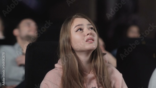 Wallpaper Mural Young woman is watching movie at cinema. emotion - interest Torontodigital.ca