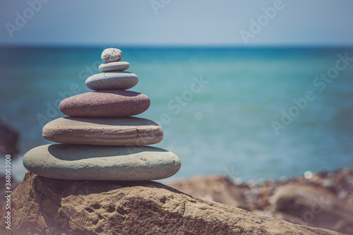 Photography Stack of zen stones near sea. Harmony, balance