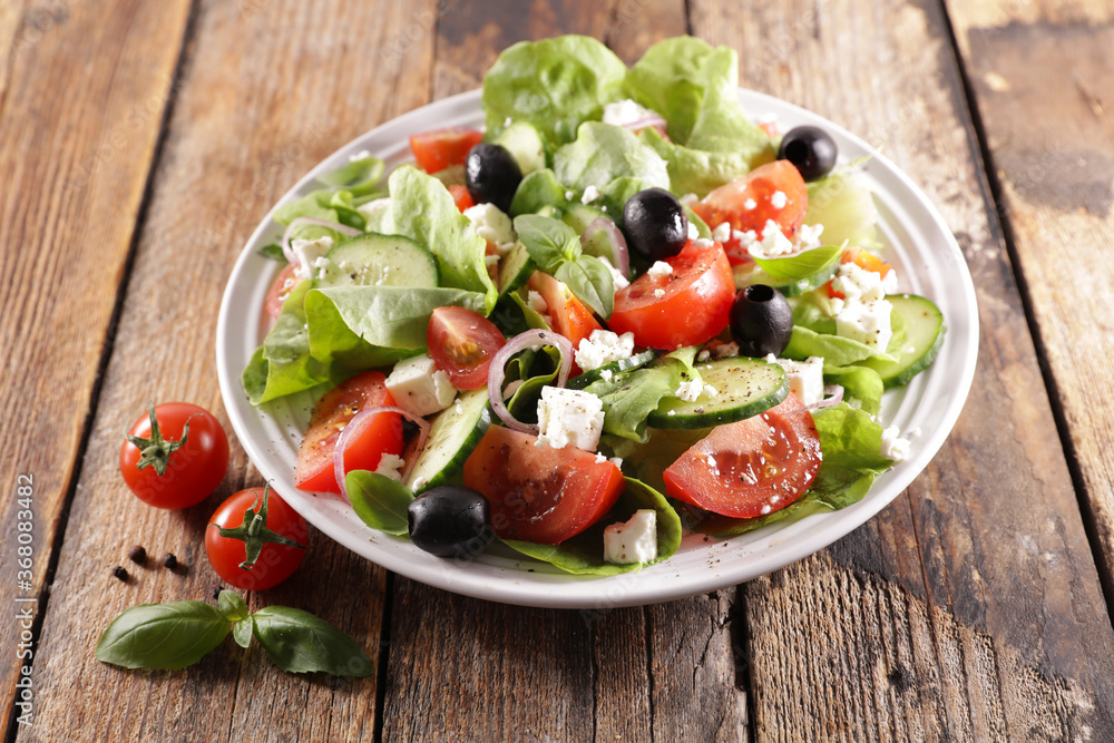 mixed vegetable salad with feta cheese, onion, olive and tomato