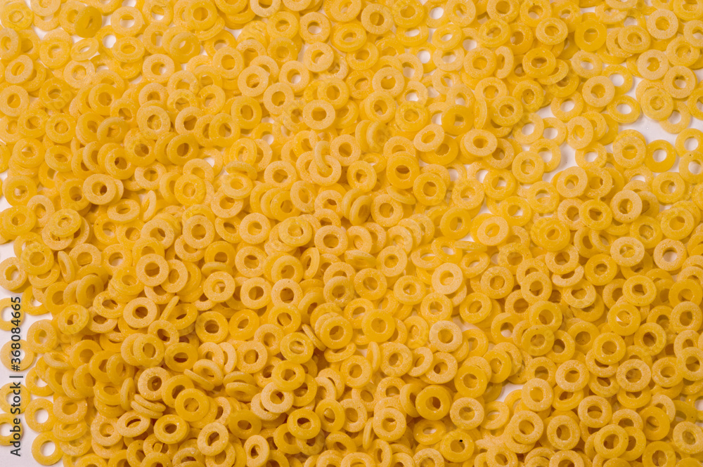 small rings Italian dry raw pasta macaroni bronze drawn full frame  top view