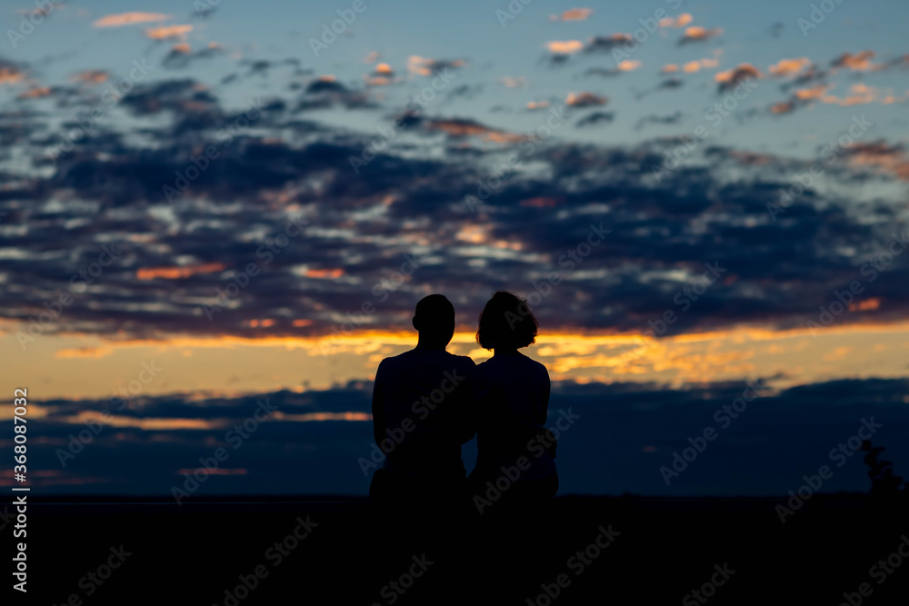 couple on the background of the dawn sky
