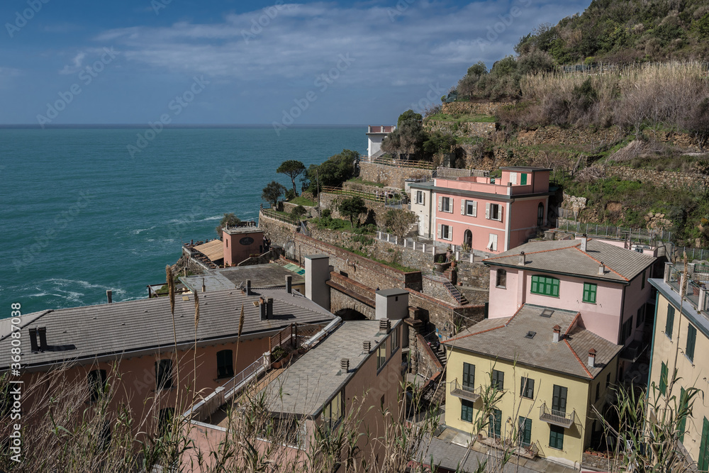 Riomaggiore village, first & most southern of Cinque Terre coastal villages, located in a small valley, has a shoreline of Mediterranean's sea Gulf of Genoa with, a beach & wharf, La Spezia, Italy.