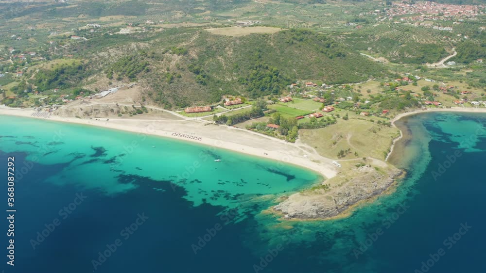 An aerial view of a blue ocean near a cliffy shore at daytime An aerial view of a blue ocean near a cliffy shore at daytime