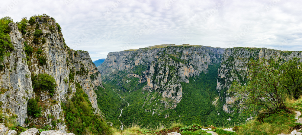 Wide panoramic view of Vikos Gorge from Oxya Viewpoint. The Vikos Gorge is listed by the Guinness Book of Records as the deepest canyon in the world.