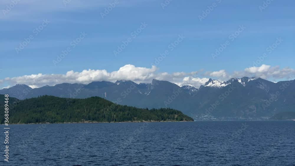 Ocean view with mountains, blue sky and white clouds at summer day.
Ocean view with mountains, blue sky and white clouds at summer day.