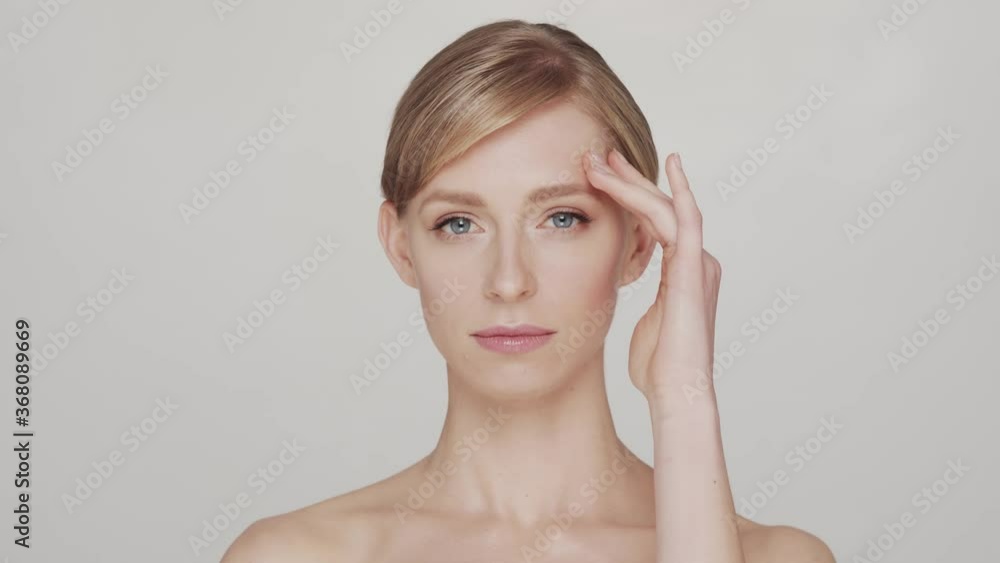 Studio portrait of young and beautiful woman over grey background Studio portrait of young and beautiful woman over grey background