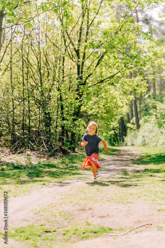 Girl running on trail in forest