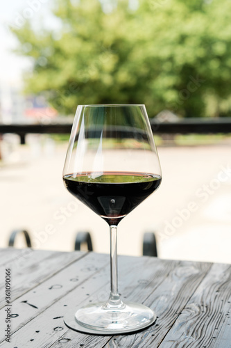 Glass of red wine on the wooden table