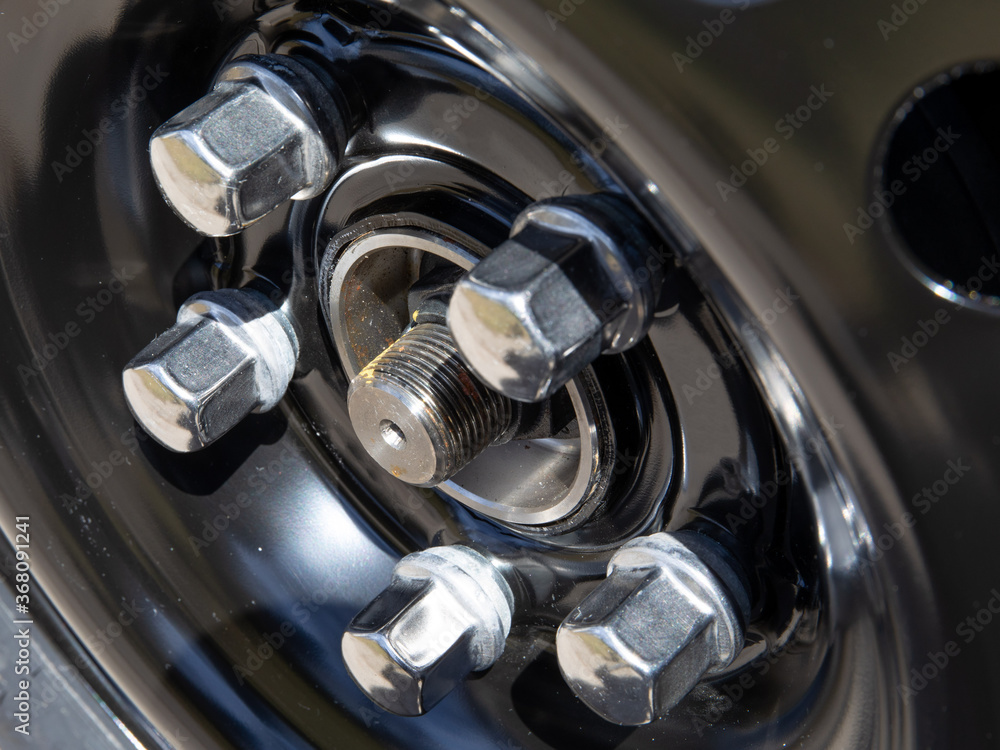 closeup details of automobile wheel lug nut