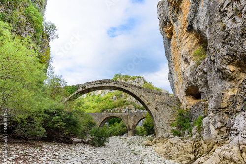 Bridge of Kokkoros or Noutsos. The stone bridge with unique arch was
first built in 1750. The bridge spans river of Vikos, just where narrowing in the river by two large rocks takes place. photo