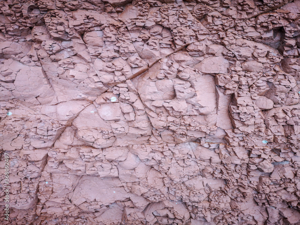 Background of a pinkish rock with small cracks Background of a pinkish rock with small cracks