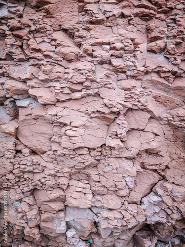 Background of a pinkish rock with small cracks