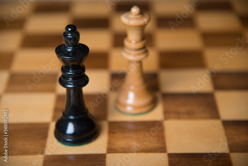 Chess pieces on a wooden board. The concept of tactical games.