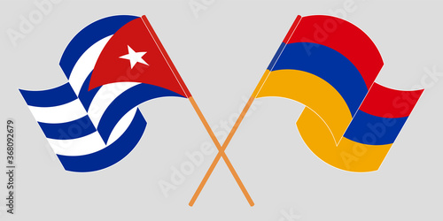 Crossed and waving flags of Cuba and Armenia