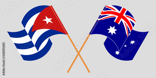 Crossed and waving flags of Cuba and Australia