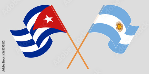 Crossed and waving flags of Cuba and Argentina