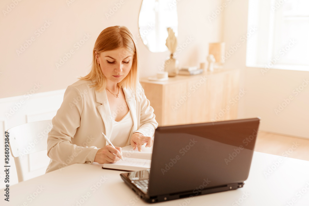 Beautiful businesswoman using laptop computer working from home Beautiful businesswoman using laptop computer working from home