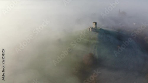 Aerial of the ruins of St. Michaels Church on Burrow Mump surrounded by mist, Burrowbridge, Somerset, England, United Kingdom photo