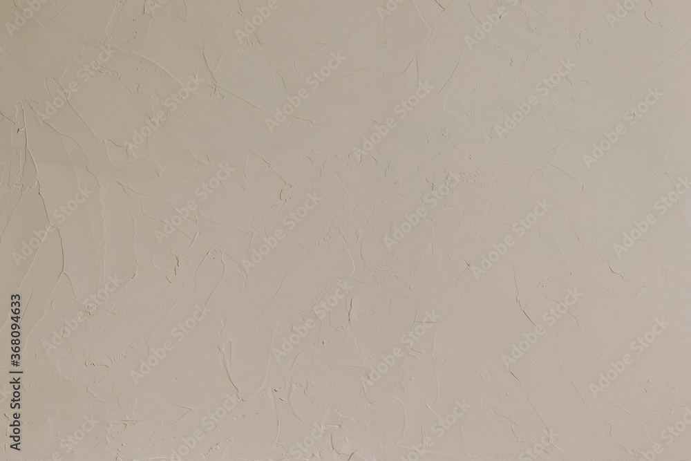 Beige textured wall detail for background. Natural color, rough surface. Flat lay, top view.