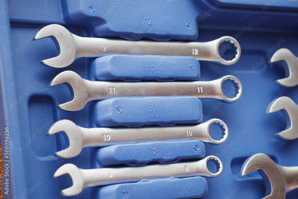 Close-up wrenches in a tool case. Chrome plated wrenches. Wrenches of different sizes and types. Close-up wrenches in a tool case. Chrome plated wrenches. Wrenches of different sizes and types.