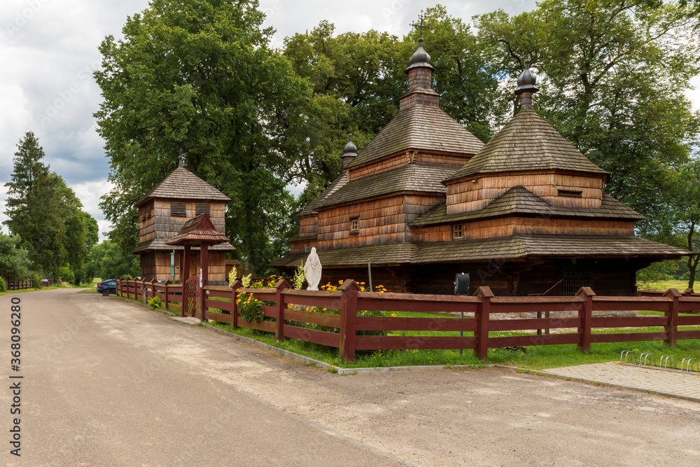 Old (built in year 1586) wooden church architecture by village road. Gorajec village, Poland, Europe.
Old (built in year 1586) wooden church architecture by village road. Gorajec village, Poland, Europe.