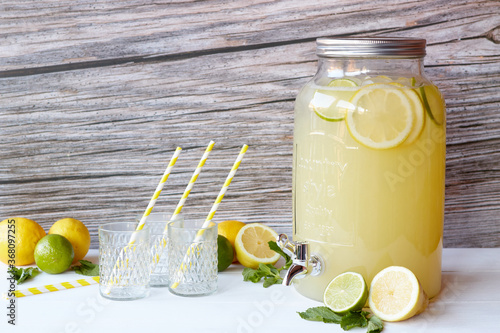 Fresh lemonade with lemons and lime in the beverage dispenser
