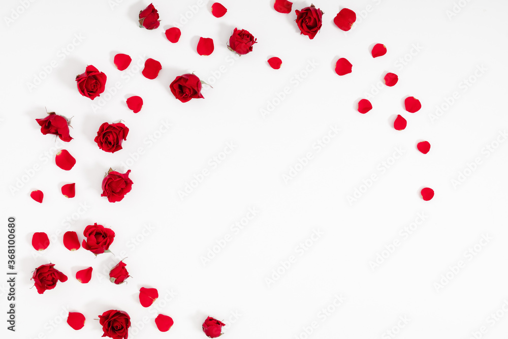 Beautiful flowers minimal composition. Red rose, rose petals on white background. Valentine's Day, Happy Women's Day, 8 March, Flat lay, top view, copy space Beautiful flowers minimal composition. Red rose, rose petals on white background. Valentine's Day, Happy Women's Day, 8 March, Flat lay, top view, copy space