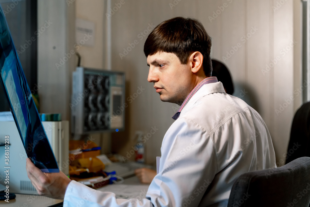 Fototapeta premium Radiologist at work. Reading MRI near computer. Medical issues. Neurosurgery concept.