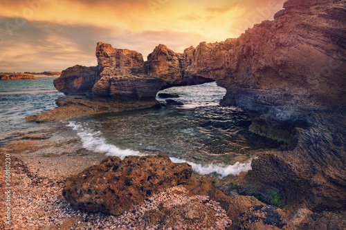 Stone arch in the stunning lagoon of Nahsholim Beach, Haifa area of Northern Israel.