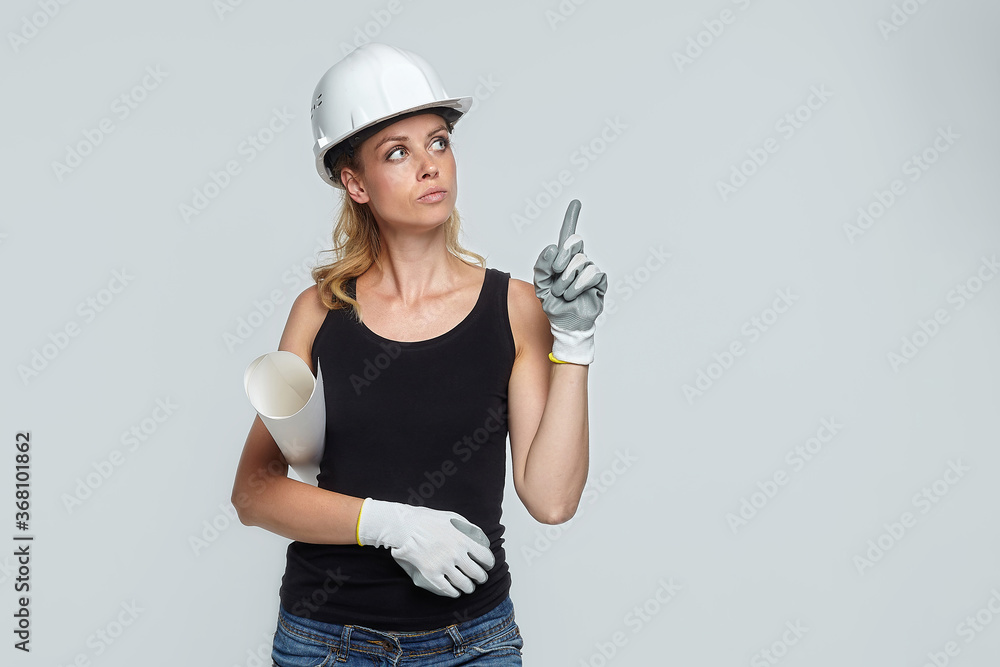 blonde woman in construction helmet points to blank field for text placement blonde woman in construction helmet points to blank field for text placement