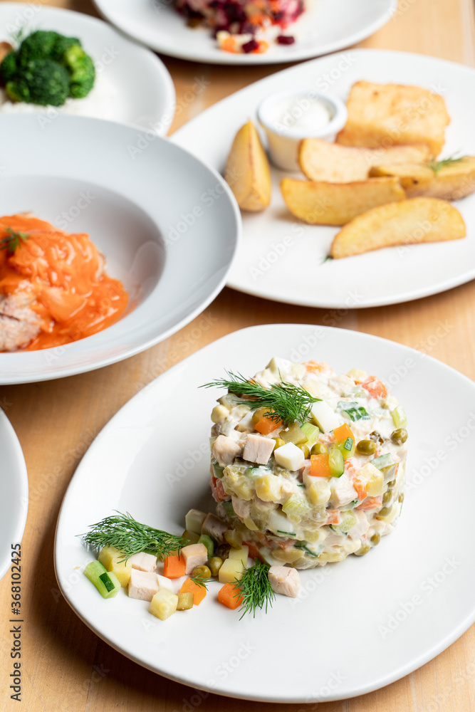 Stolichny salad as a part of nutritious set meal in a russian restaurant Stolichny salad as a part of nutritious set meal in a russian restaurant