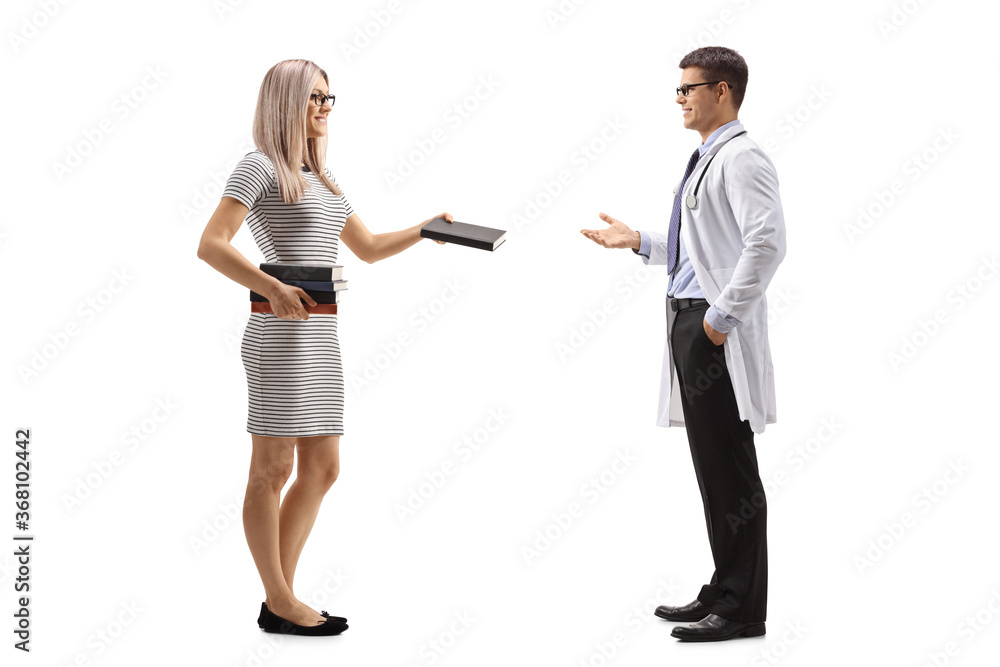 Young blond woman giving a book to a male doctor Young blond woman giving a book to a male doctor