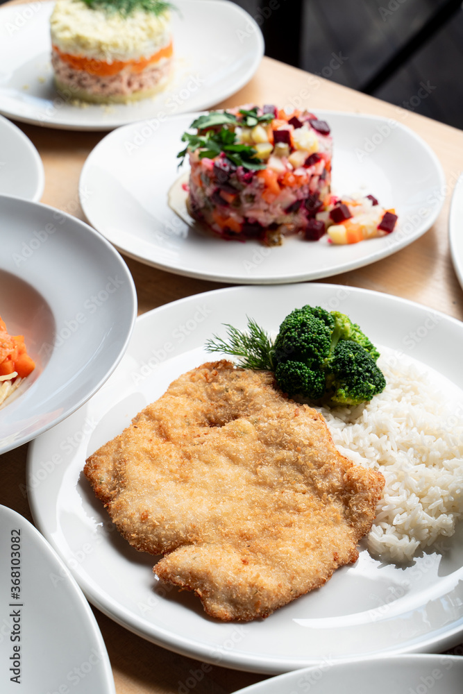 Simple austrian schnitzel with white boiled rice, a part of set menu in a cafe Simple austrian schnitzel with white boiled rice, a part of set menu in a cafe