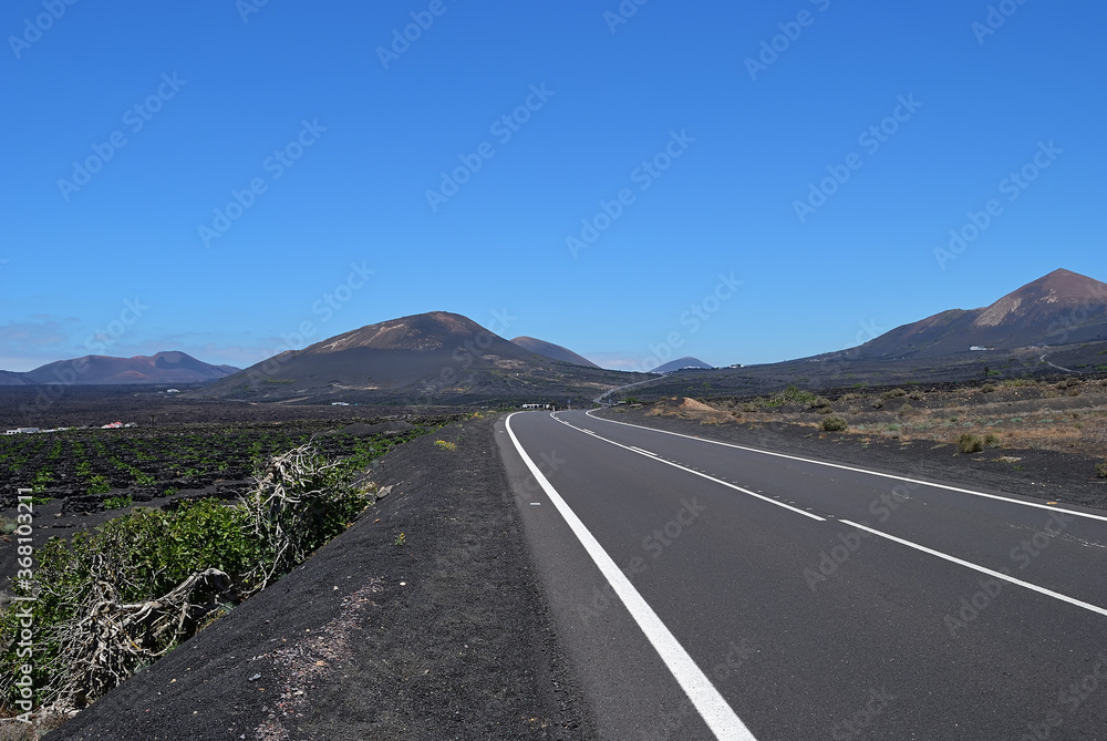 Tar road between volcanic landscape. Lanzarote. Spain