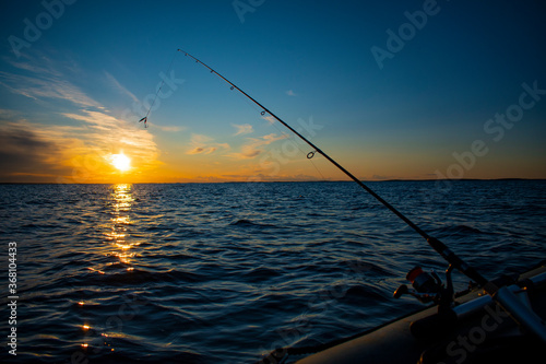 Fishing in a boat at sunset © Максим Старчик