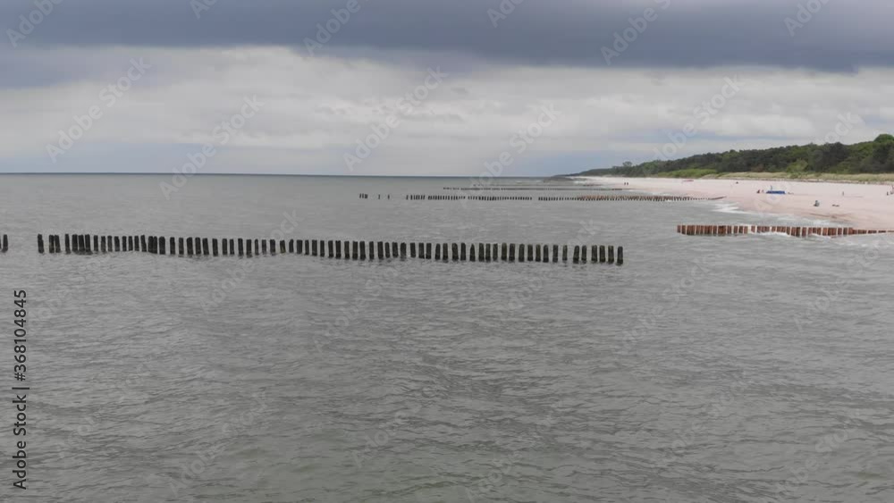 high view of view of the sandy beach, breakwaters and baltic sea waves high view of view of the sandy beach, breakwaters and baltic sea waves