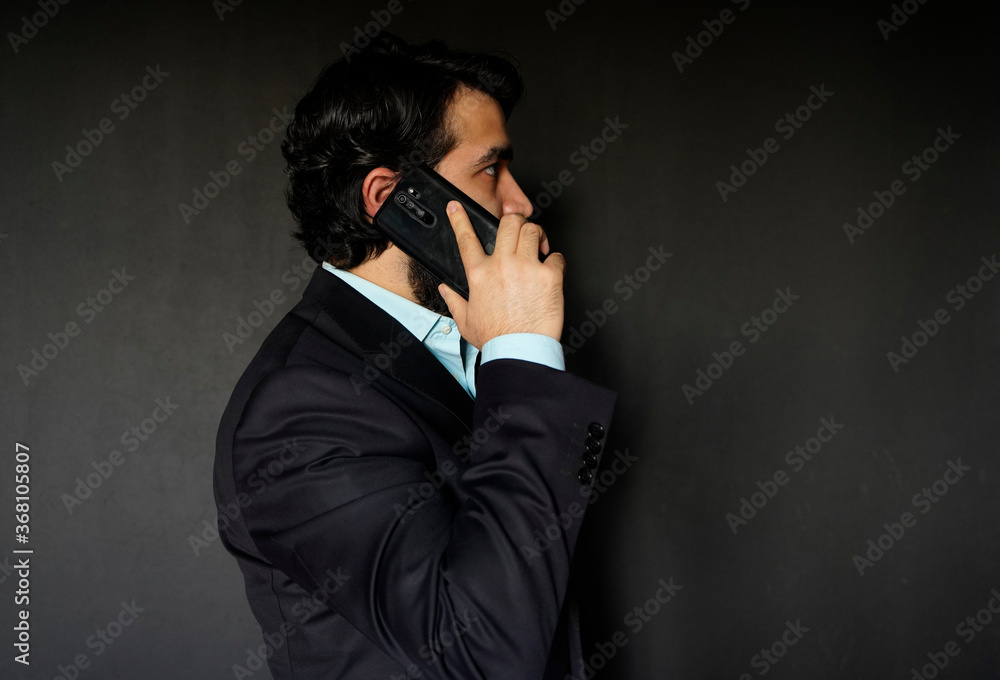 bearded businessman mid adult looking working on his smart phone bearded businessman mid adult looking working on his smart phone