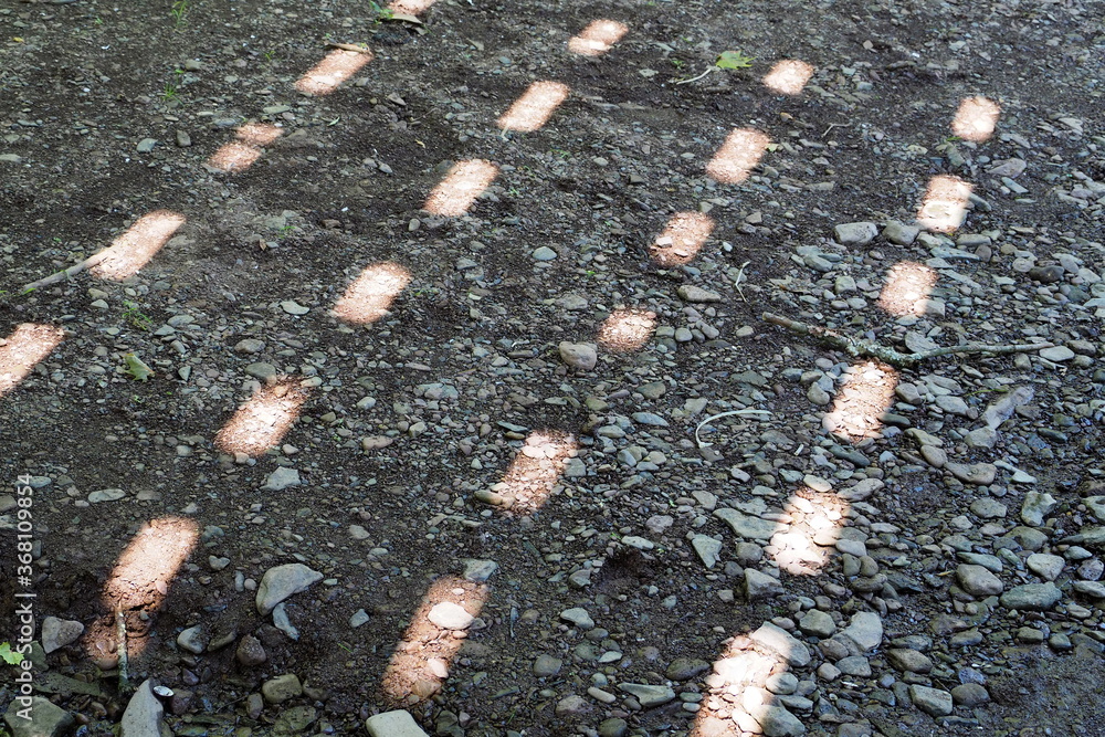 Fototapeta premium The sun's reflection shows a pattern on the ground.