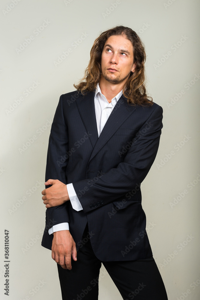Portrait of handsome bearded businessman with long hair Portrait of handsome bearded businessman with long hair