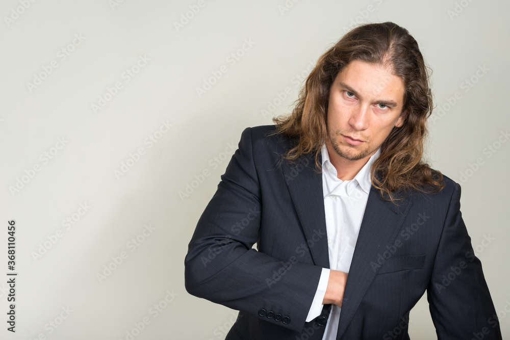 Portrait of handsome bearded businessman with long hair Portrait of handsome bearded businessman with long hair