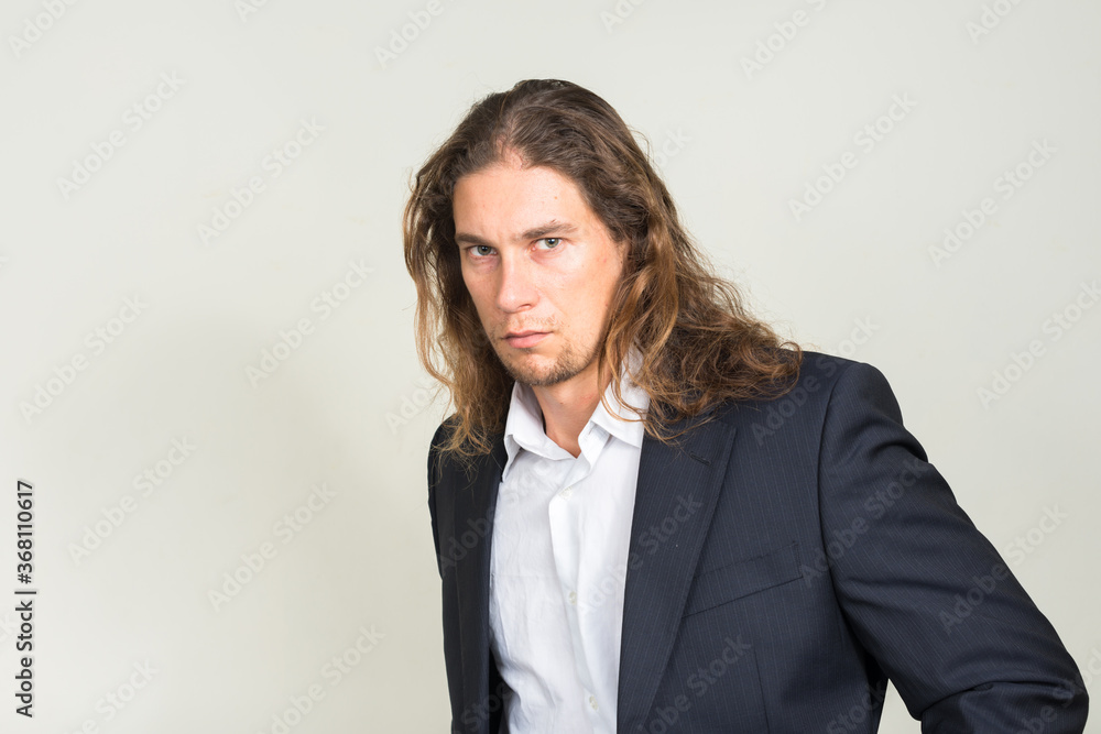 Portrait of handsome bearded businessman with long hair Portrait of handsome bearded businessman with long hair