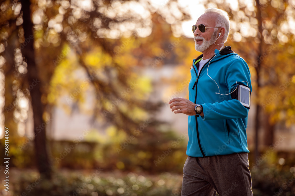Senior man jogging outdoors.